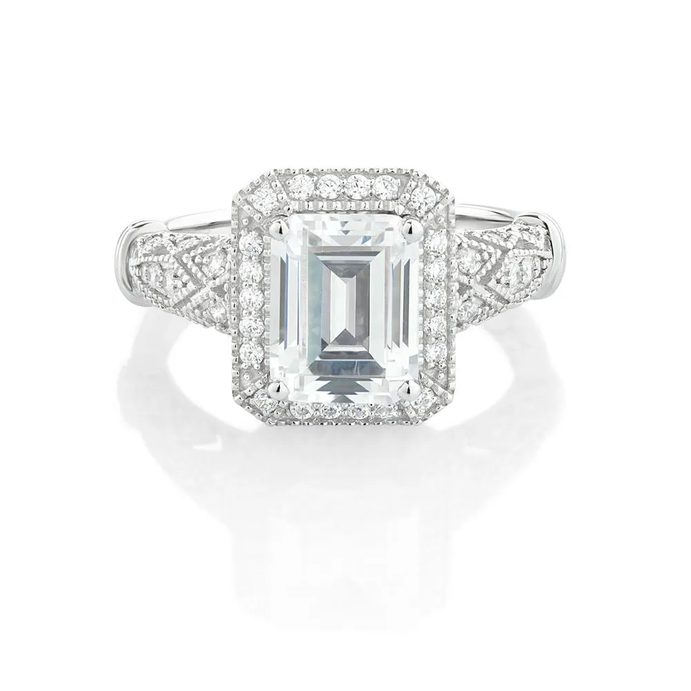Emerald Cut and Round Brilliant halo engagement ring with 2.9 carats* of diamond simulants in 10 carat white gold